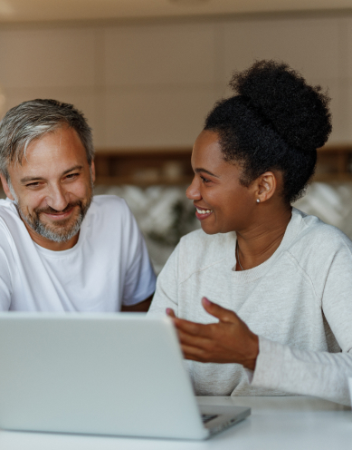 A man and a woman using a laptop